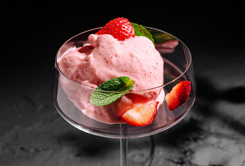 Delicious strawberry sorbet served in an elegant glass dessert dish