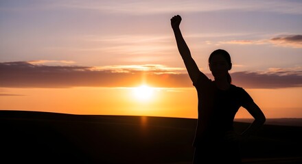 Fototapeta premium Silhouette of woman raising fist at sunrise, empowerment concept