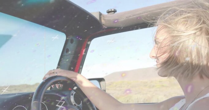 Woman driving red convertible in desert, glitch lights sweeping windshield showing automotive tech