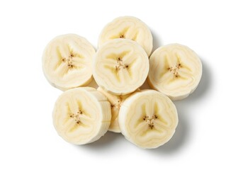 Pile of sliced ripe bananas on white top down view fruit food