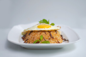 Delicious Biryani Rice and Omelet on White Dish with White Background.