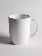 Obraz premium White ceramic mug plain design glossy surface clean empty isolated on light background simple style kitchenware modern minimalistic