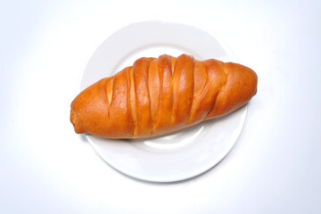 Freshly Baked Bun on White Dish. Minimal Food Photography.