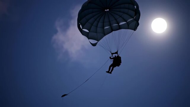 Skydiver silhouette with parachute against the sun  sky.