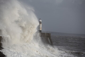 Giant waves hitting the sea wall and lighthouse at Porthcawl.