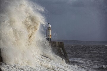 Giant waves hitting the sea wall and lighthouse at Porthcawl.