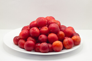 red cherry plum on the white dish