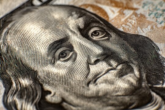 Closeup of United States dollar featuring Benjamin Franklin's portrait highlighting intricate details of the currency design and texture in a macro view - Powered by Adobe