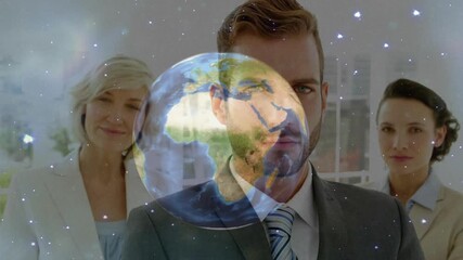 Team standing in office as globe fading in and spinning with stars illustrating business strategy - Powered by Adobe