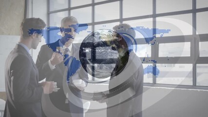 Team sipping coffee by window while map fading in initiating rotating globe showing global business - Powered by Adobe