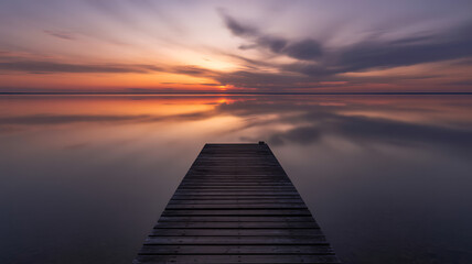 Serene Lake Sunset with Wooden Pier and Reflections