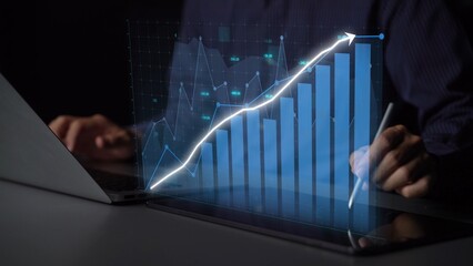 A modern representation of business growth with a digital chart displayed on a laptop, symbolizing financial analysis, strategy, and technological advancement in a dark setting. Copula