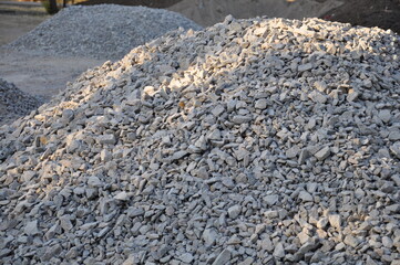 Stone aggregate pile background. Heap of crushed stone texture.