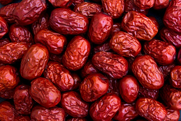 Dried red jujubes isolated on white background. They are a good source of fiber, antioxidants, and various vitamins and minerals, including vitamin C, potassium, and iron. 