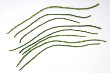 Yardlong beans isolated on white background. They are a good source of vitamins A, C, and K, as...