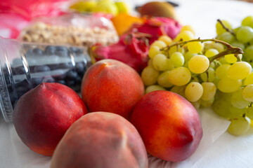 Assortment of fresh fruits peaches, grapes, and berries