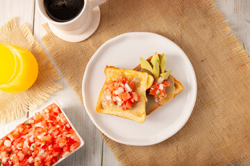 Breakfast toast with refried beans, avocado, melted cheese and mexican pico de gallo sauce. Easy and healthy homemade recipe that can be made in the oven, frying pan or air fryer.