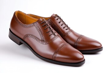 Elegant brown leather brogue shoes resting on white background