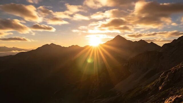 Sunrise Over Mountain Peaks in Timelapse - The video captures the sun rising above rugged mountain peaks, casting a warm glow across the landscape.