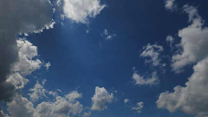 A breathtaking view of a bright blue sky filled with dramatic white clouds, perfect for backgrounds in travel, nature, and inspirational marketing campaigns