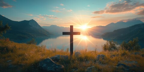 Scenic sunrise over a tranquil lake with a wooden cross on the shore surrounded by mountains and lush greenery