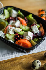 Healthy vegetable salad with tomatoes, peppers, cucumbers, onion and cheese.
