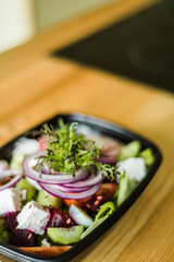 Healthy vegetable salad with tomatoes, peppers, cucumbers, onion and cheese.