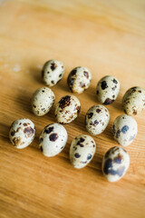 Fresh raw quail eggs on wooden table.