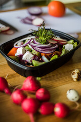 Healthy vegetable salad with tomatoes, peppers, cucumbers, onion and cheese.