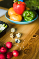 Fresh raw quail eggs on wooden table.
