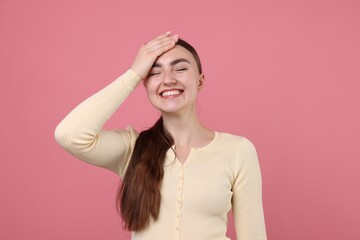 Beautiful woman laughing on pink background. Positive emotion