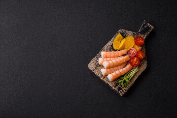 Bowl with shrimps, seafood, rice, oranges, tomatoes with sauce. Bowl with prawns