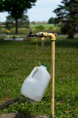 water spout with a gallon jug tied to it 