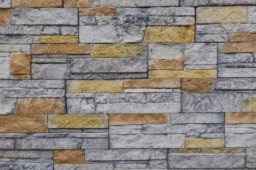 Textured stone wall with varying colors and patterns