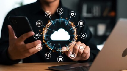 A man uses a smartphone and laptop to manage a cloud computing network of interconnected digital services - Powered by Adobe