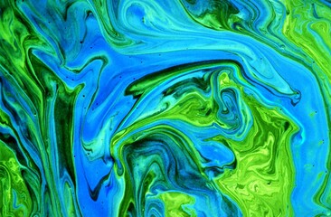 Abstract background of acrylic paint in blue and green tones. Liquid marble pattern