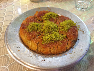 Kunefe dessert with melted cheese and sweet syrup, traditional Turkish pastry served warm.