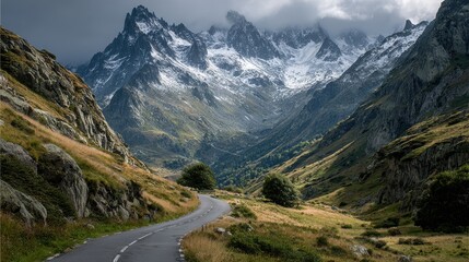 Fototapeta premium Snowy road leading to mountain peak in french alps at sunrise on a winter day