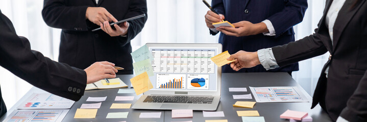 Analyst team use sticky note for creative and analytic brainstorm for business idea with BI data dashboard on laptop screen. Analysis financial data visualization tech for marketing strategy. Prodigy