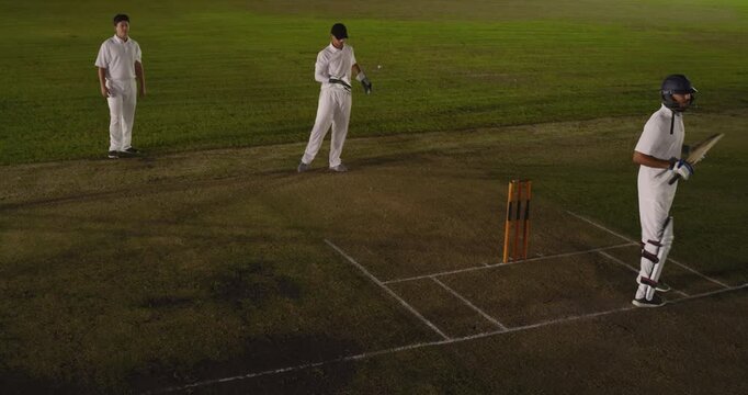 Delivery sparking Indian batsman missing on cricket pitch keeper catching wickets under lights