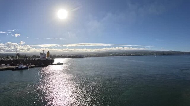 USA, Hawaii, The Big Island, Hilo, Bay - timelapse port departure by cruise ship early in the evening during sunset passing Wainaku, Bayfront