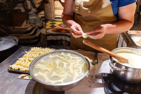 A female chef shows the process of making cheese.