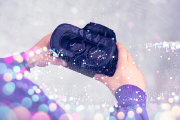 Close-up of hands holding virtual reality goggles with overlay of futuristic glowing bokeh lights. Concept of VR-technologies in investment analytics, digital innovation.