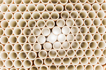 a multitude of paper drinking straws lying in rows on top of each other