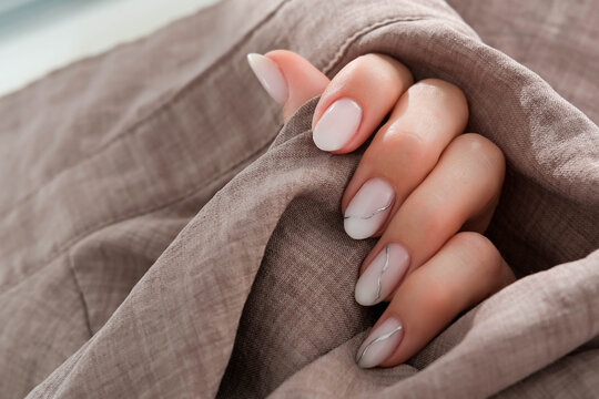Woman's hand with a beautiful oval-shaped manicure. Autumn trend