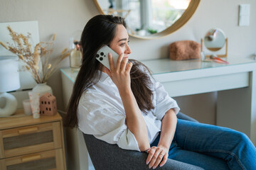 Young woman is having a phone conversation on a smartphone. Working online.