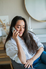 Young woman is having a phone conversation on a smartphone. Working online.