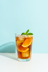 Summer cold drink on colored background with hard shadows.