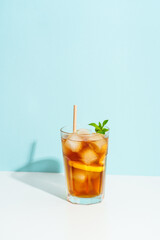 Summer cold drink on colored background with hard shadows.