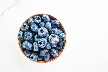 Blueberries in the bowl on white.